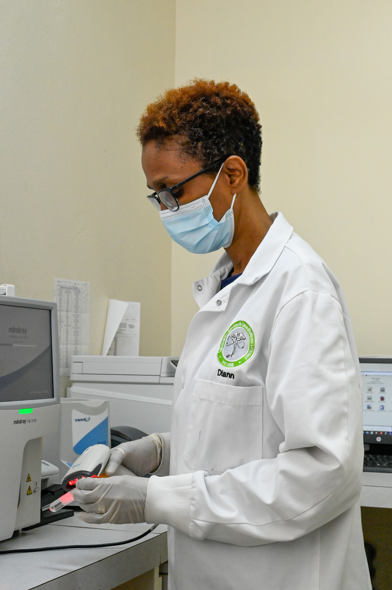 Laboratory Services & Consultations Limited technician processing a sample at M-Care